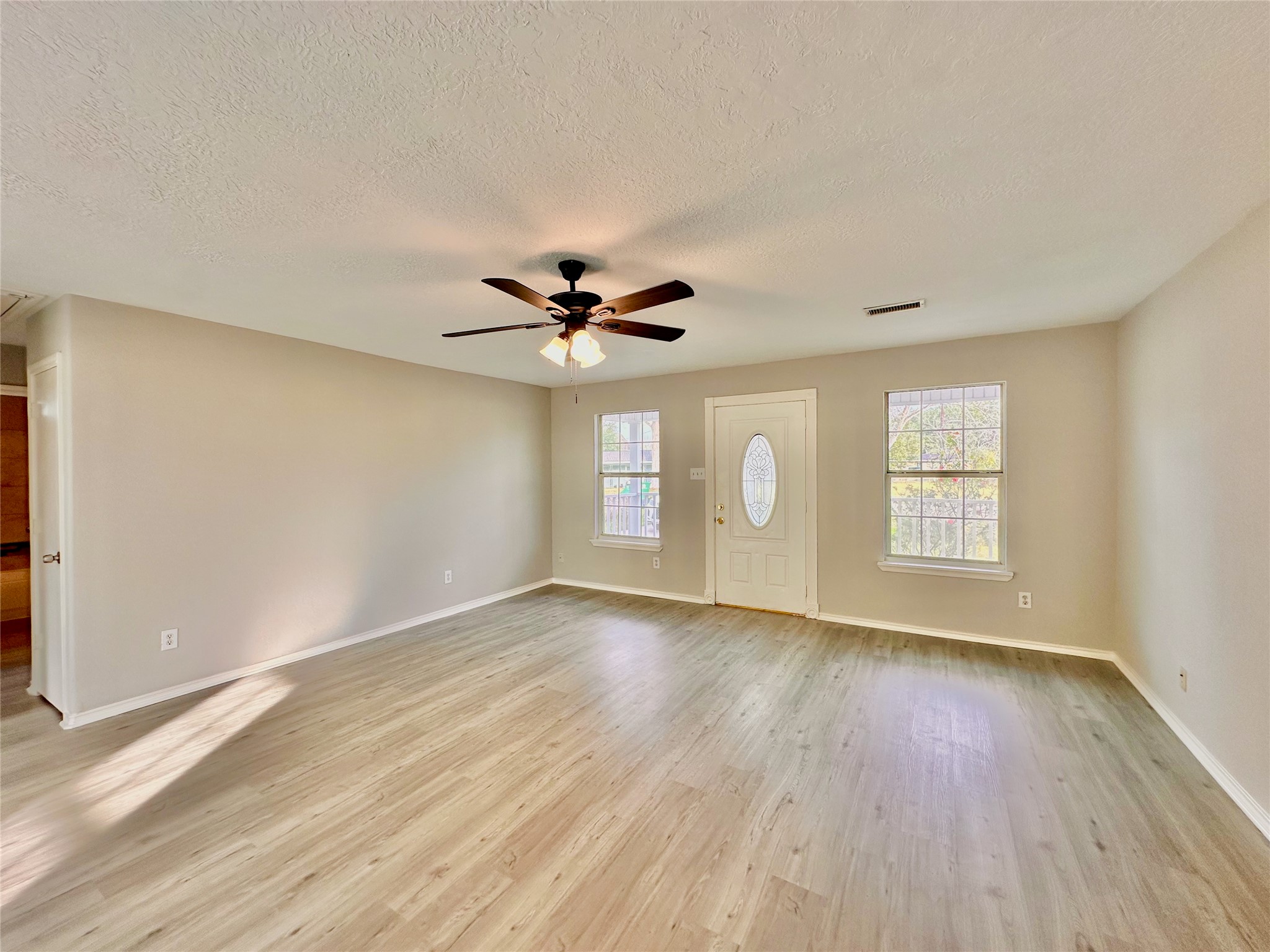 15134 Alkay Street Houston, TX 77053 - Photo 5 of 25 a view of an empty room with window and wooden floor
