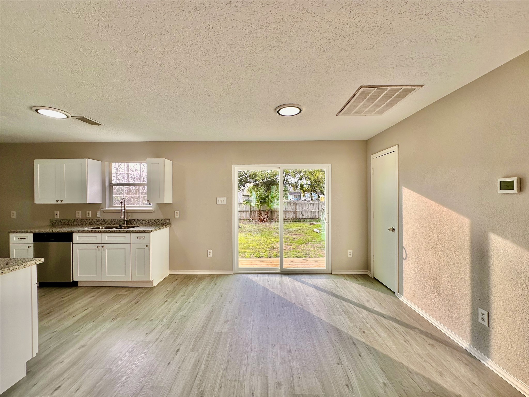 15134 Alkay Street Houston, TX 77053 - Photo 7 of 25 a kitchen with a wooden floor and window