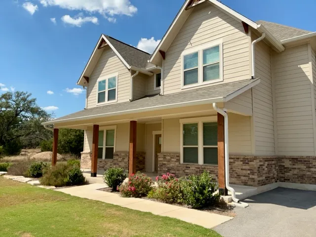 a front view of a house with a yard