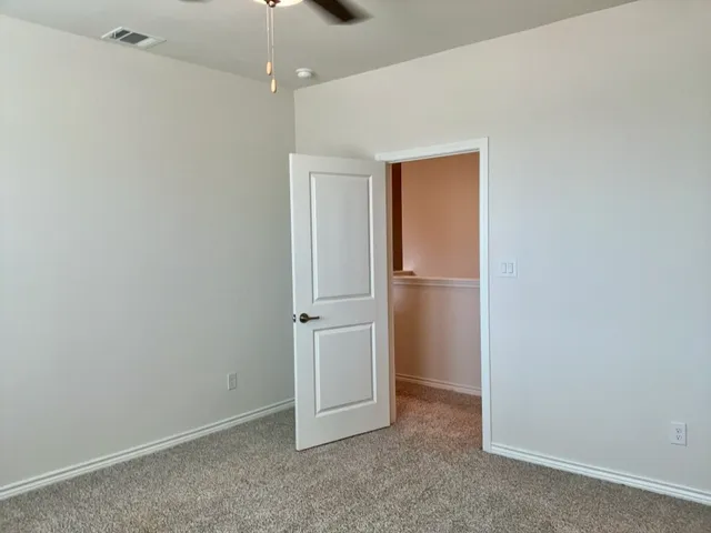 an empty room with closet area