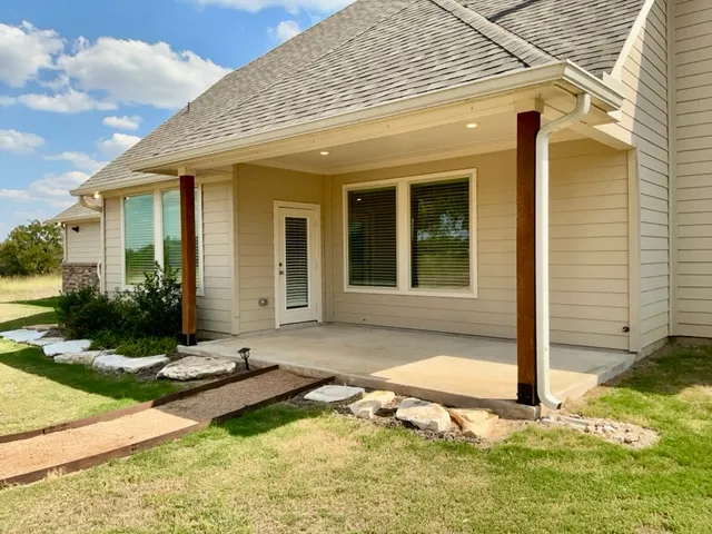 a view of a house with backyard and sitting area