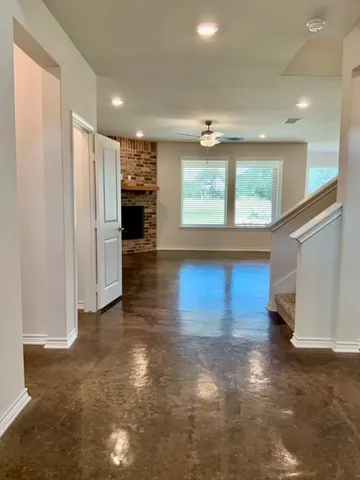 a view of a room with furniture and window