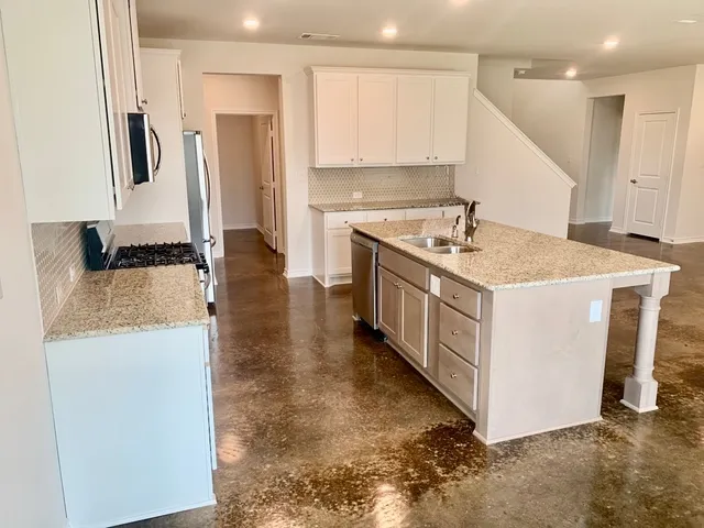 a kitchen with a sink stove and refrigerator