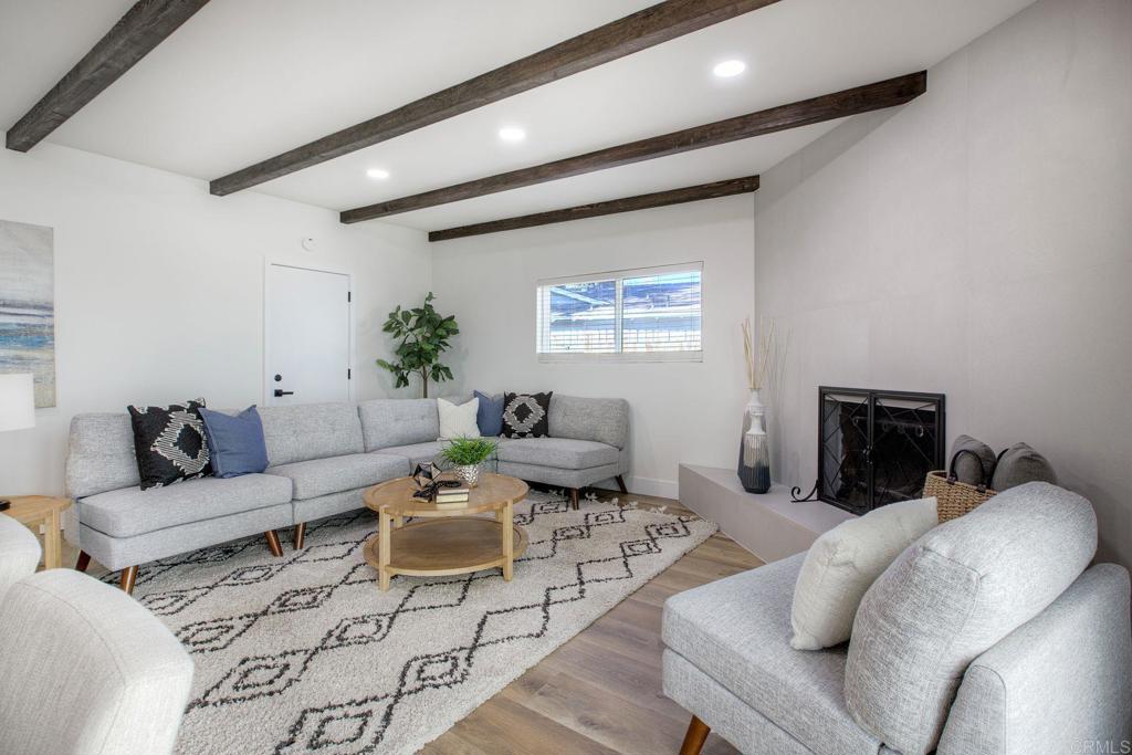 728 Hackberry Place Fallbrook, CA 92028 - Photo 11 of 23 a living room with furniture a rug and a fireplace