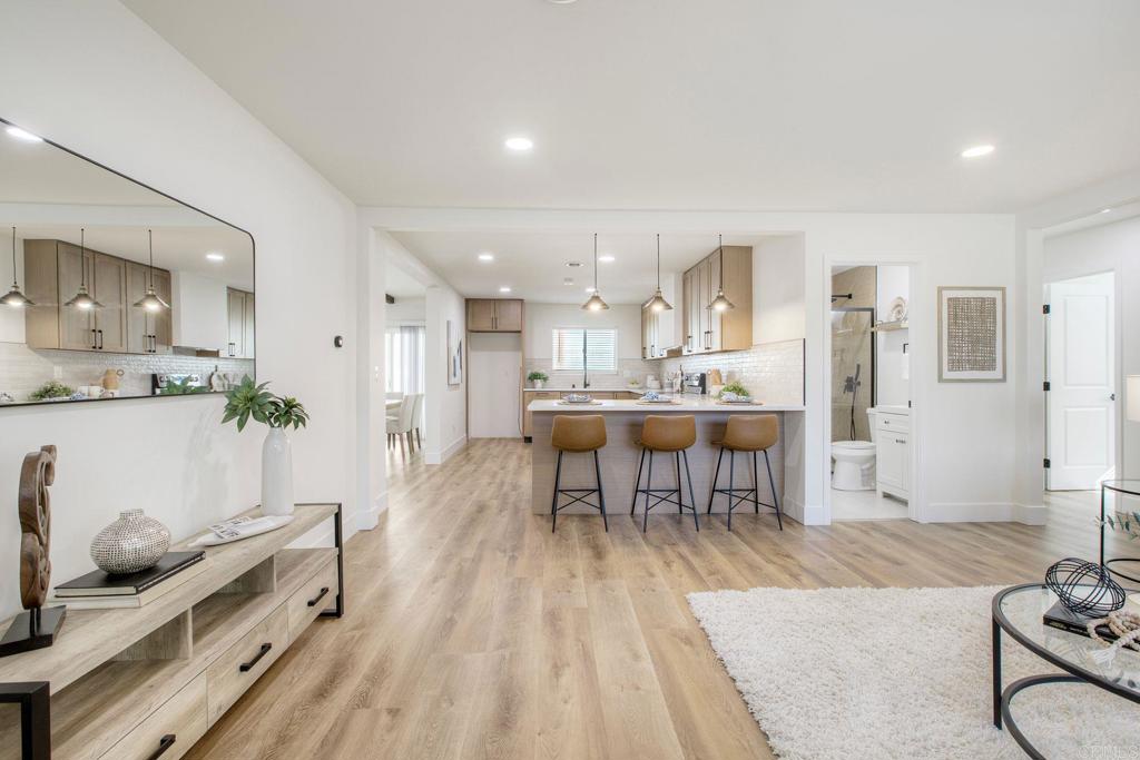 728 Hackberry Place Fallbrook, CA 92028 - Photo 2 of 23 a living room with stainless steel appliances kitchen island granite countertop furniture and a kitchen view