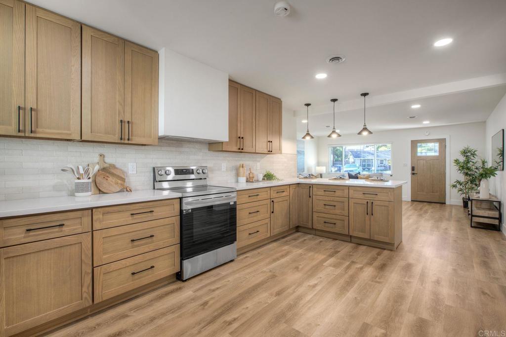 728 Hackberry Place Fallbrook, CA 92028 - Photo 6 of 23 a kitchen with stainless steel appliances sink stove and cabinets