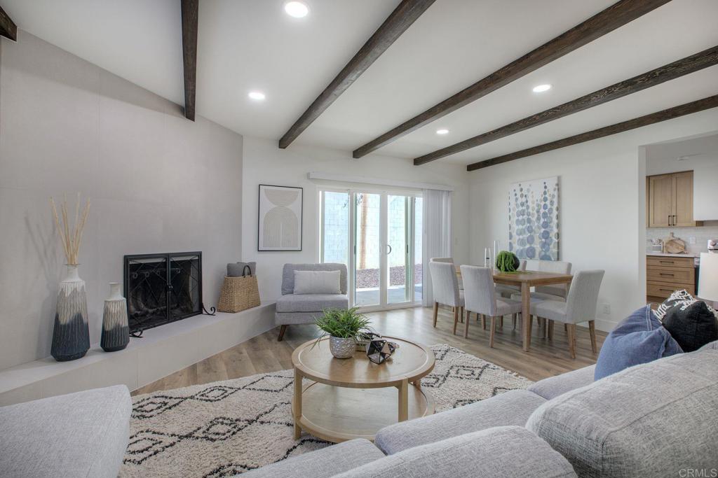 728 Hackberry Place Fallbrook, CA 92028 - Photo 10 of 23 a living room with furniture a fireplace and a flat screen tv
