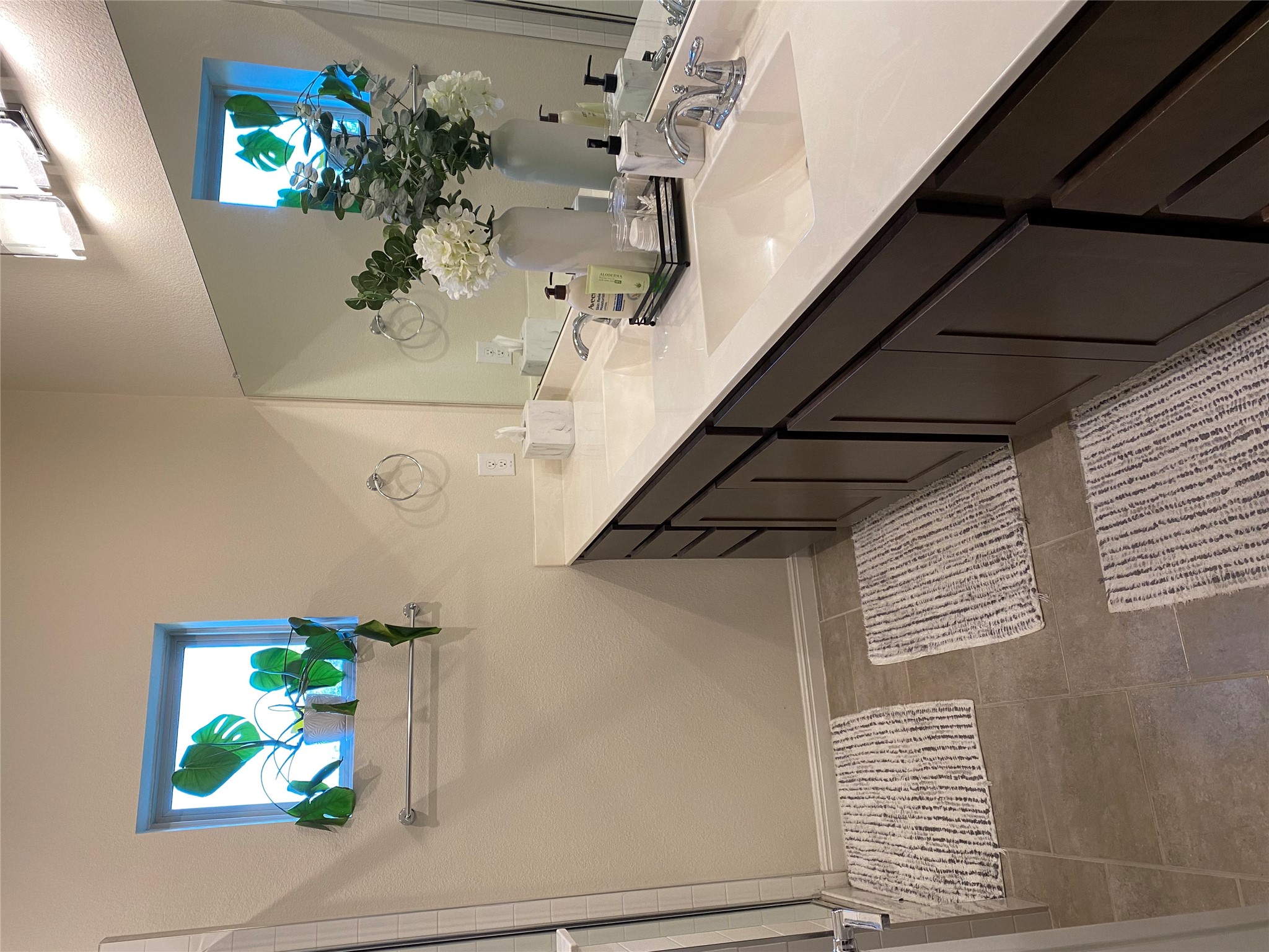 5801 Charles Merle Dr., Unit A Austin, TX 78747 - Photo 13 of 22 Primary bathroom includes a double vanity, stall shower, and dark patterned tile flooring. Previously occupied by tenant.