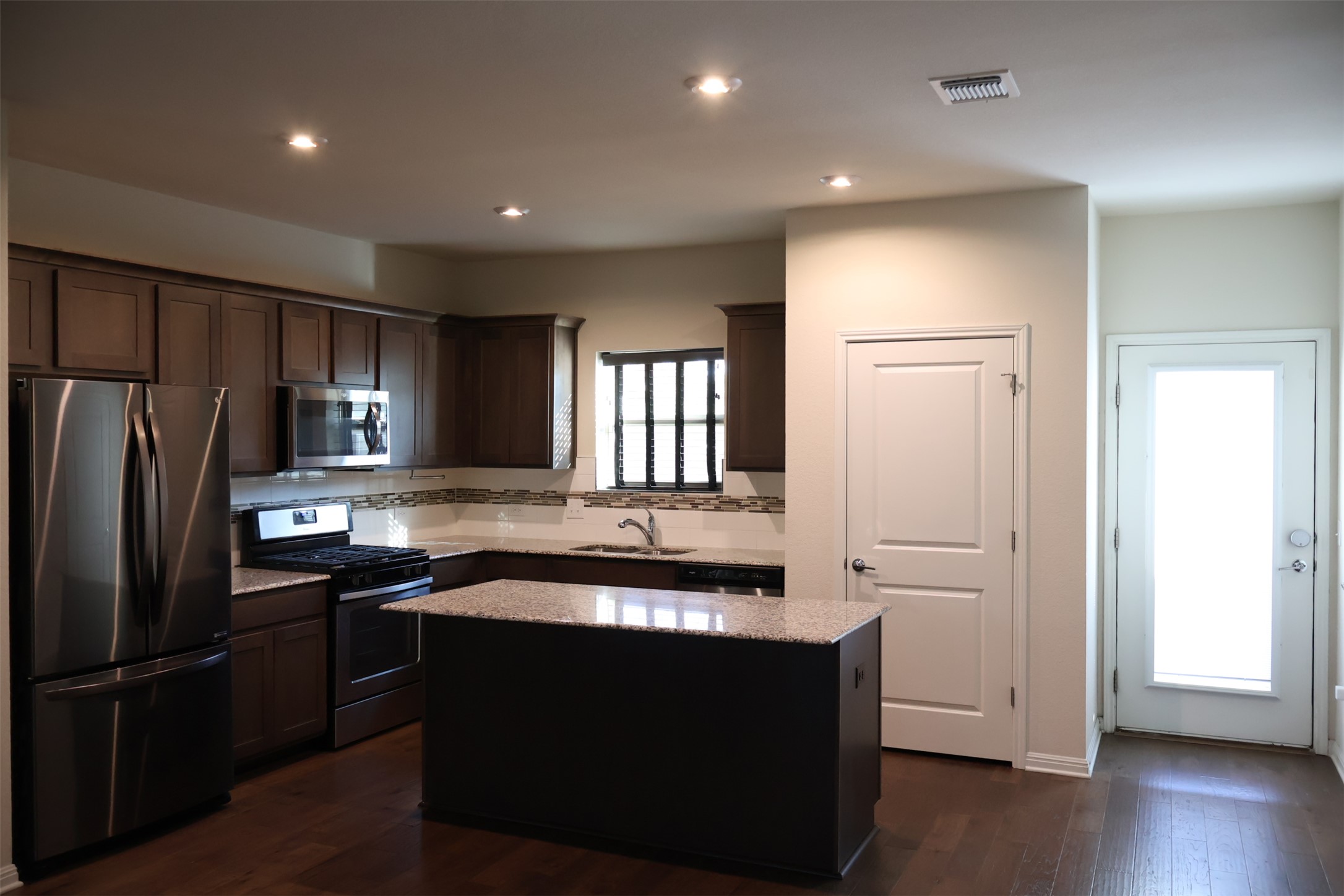 5801 Charles Merle Dr., Unit A Austin, TX 78747 - Photo 7 of 22 Kitchen leads to the backyard.