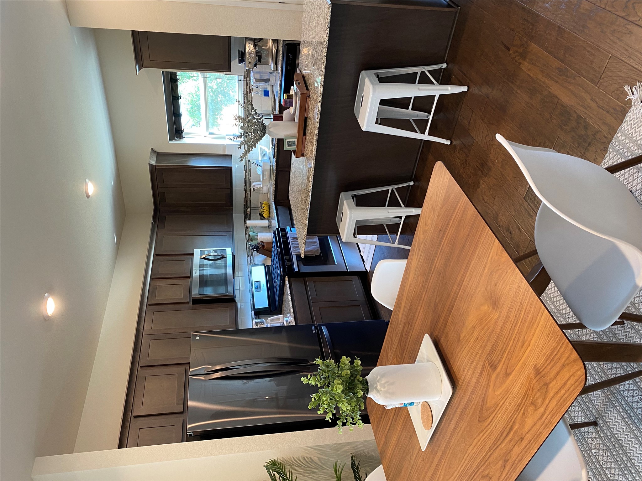 5801 Charles Merle Dr., Unit A Austin, TX 78747 - Photo 8 of 22 Spacious kitchen with stainless steel appliances, a center island, and rich dark wood cabinetry (refrigerator conveys with property). Previously occupied by tenant.