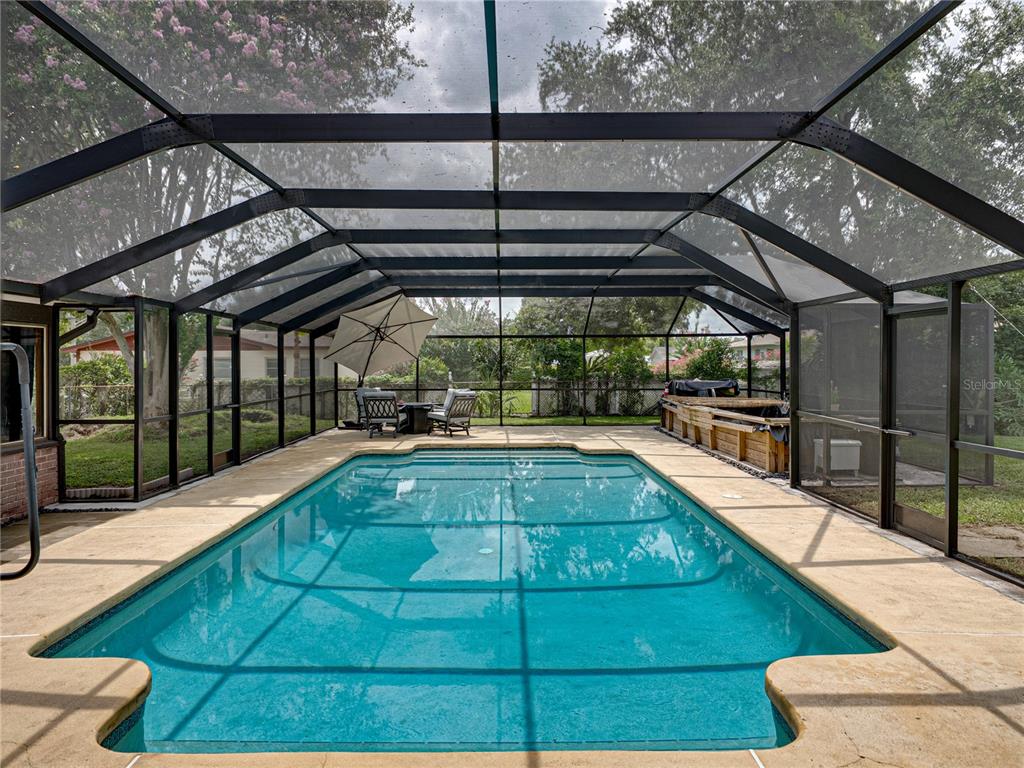 609 West Pipkin Road Lakeland, FL 33813 - Photo 2 of 72 a view of a swimming pool with a patio