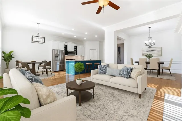 a living room with furniture and a chandelier