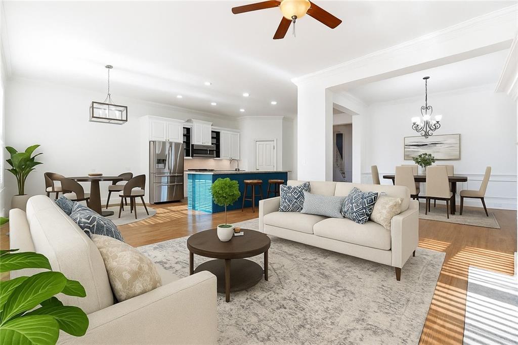 6961 Fellowship Lane Flowery Branch, GA 30542 - Photo 12 of 47 a living room with furniture and a chandelier