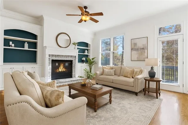 a living room with furniture a flat screen tv and a fireplace