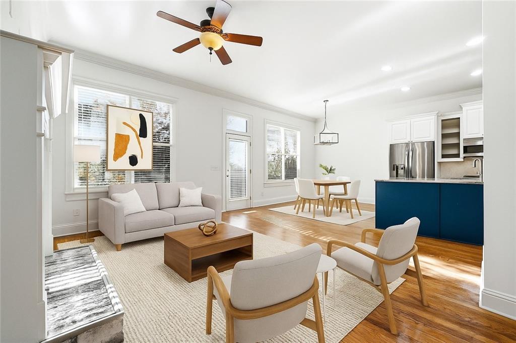 6961 Fellowship Lane Flowery Branch, GA 30542 - Photo 16 of 47 a living room with furniture a chandelier and a table