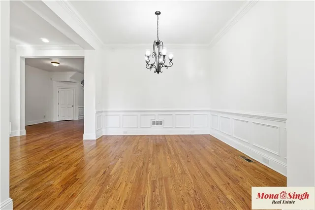a view of a room with wooden floor