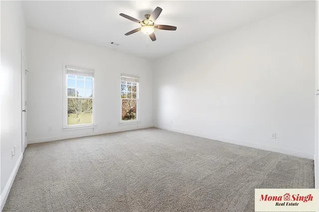 a view of room with a ceiling fan and window