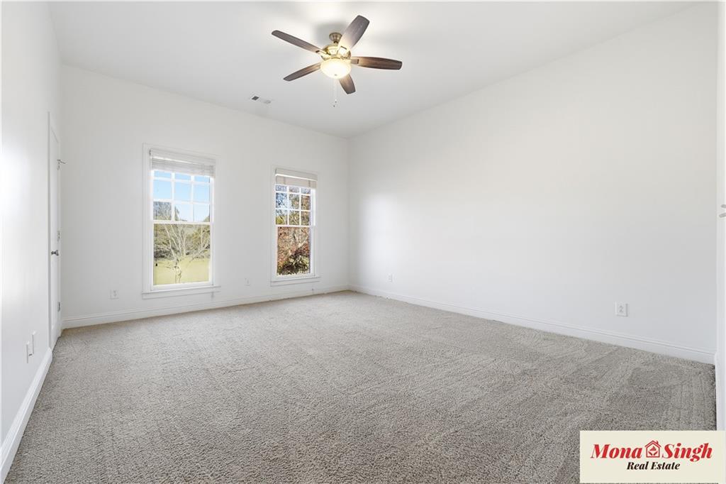 6961 Fellowship Lane Flowery Branch, GA 30542 - Photo 18 of 47 a view of room with a ceiling fan and window