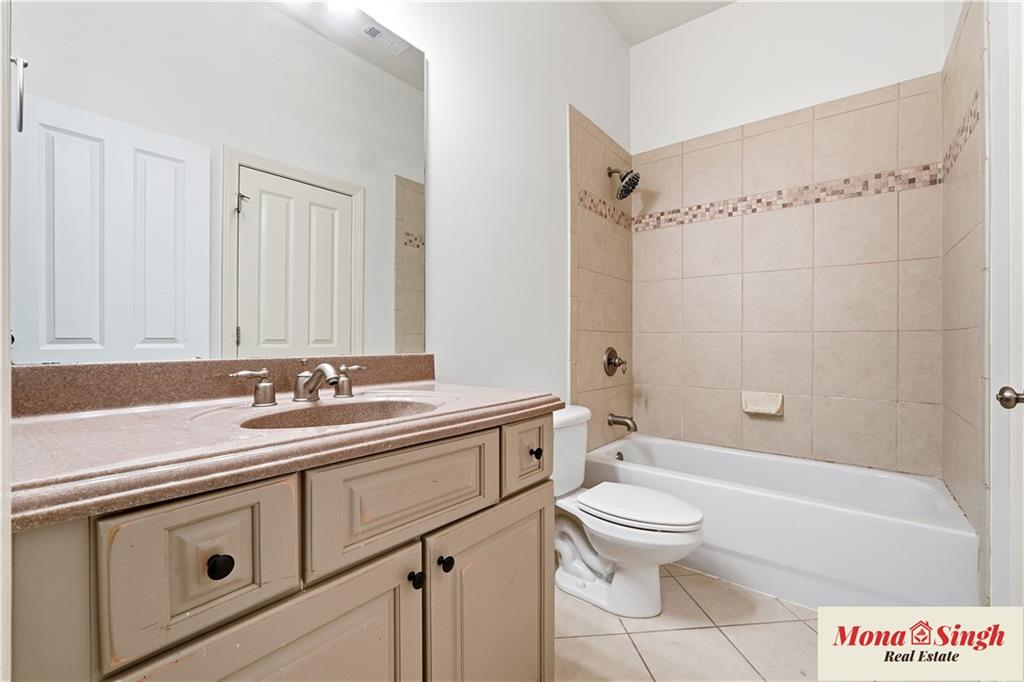 6961 Fellowship Lane Flowery Branch, GA 30542 - Photo 20 of 47 a bathroom with a sink a toilet and a bathtub