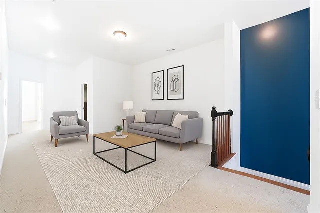 a living room with furniture and a wall painting