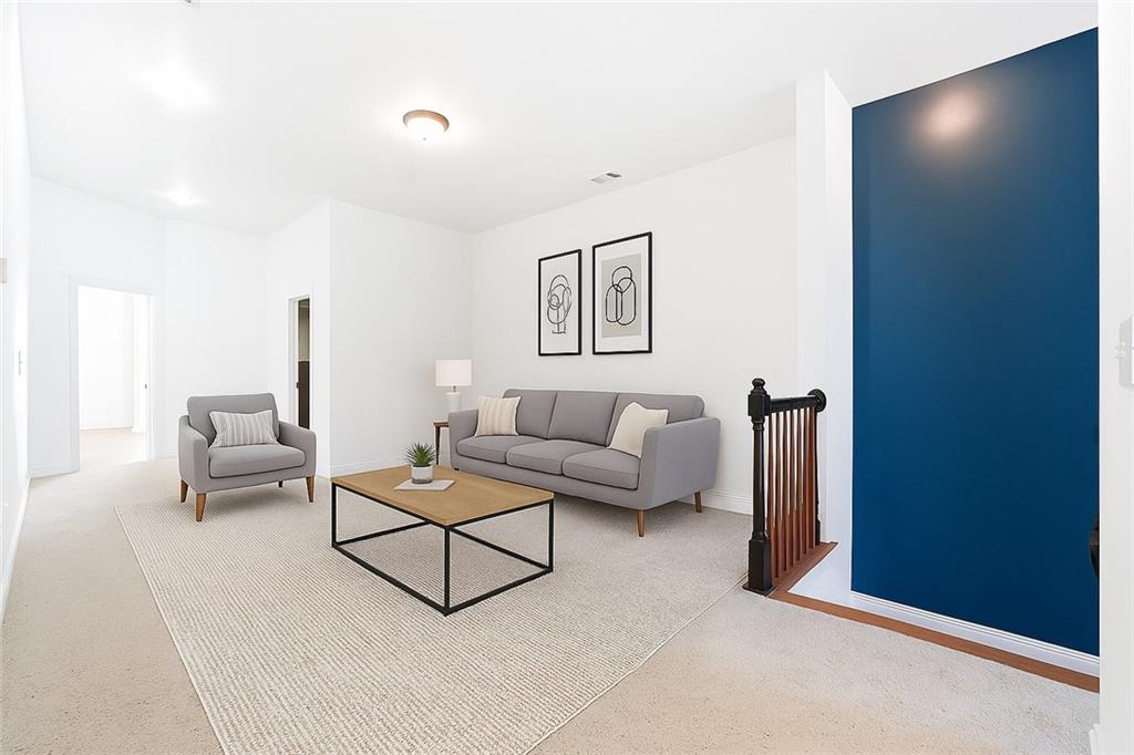 6961 Fellowship Lane Flowery Branch, GA 30542 - Photo 22 of 47 a living room with furniture and a wall painting