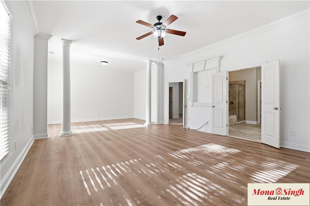 6961 Fellowship Lane Flowery Branch, GA 30542 - Photo 24 of 47 a view of a room with wooden floor and a ceiling fan