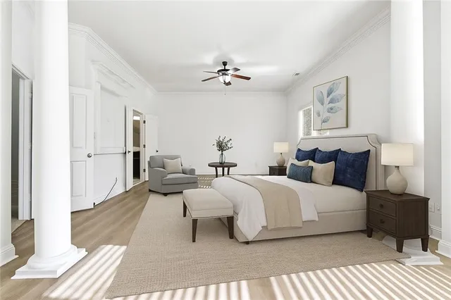 a spacious bedroom with a bed lamp on wall and a window