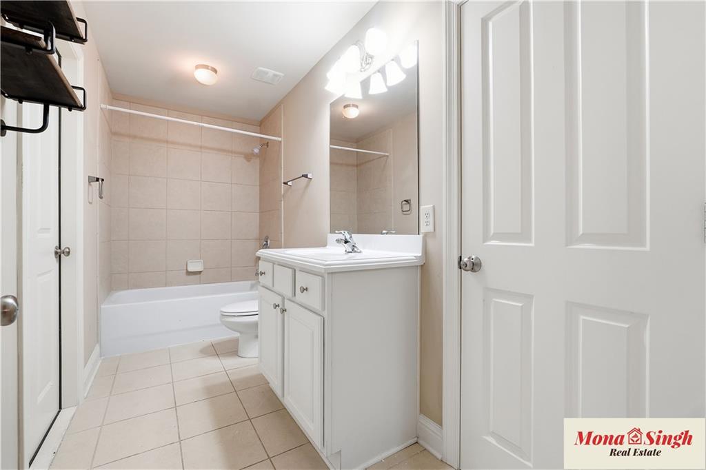 6961 Fellowship Lane Flowery Branch, GA 30542 - Photo 31 of 47 a bathroom with a sink a toilet and shower