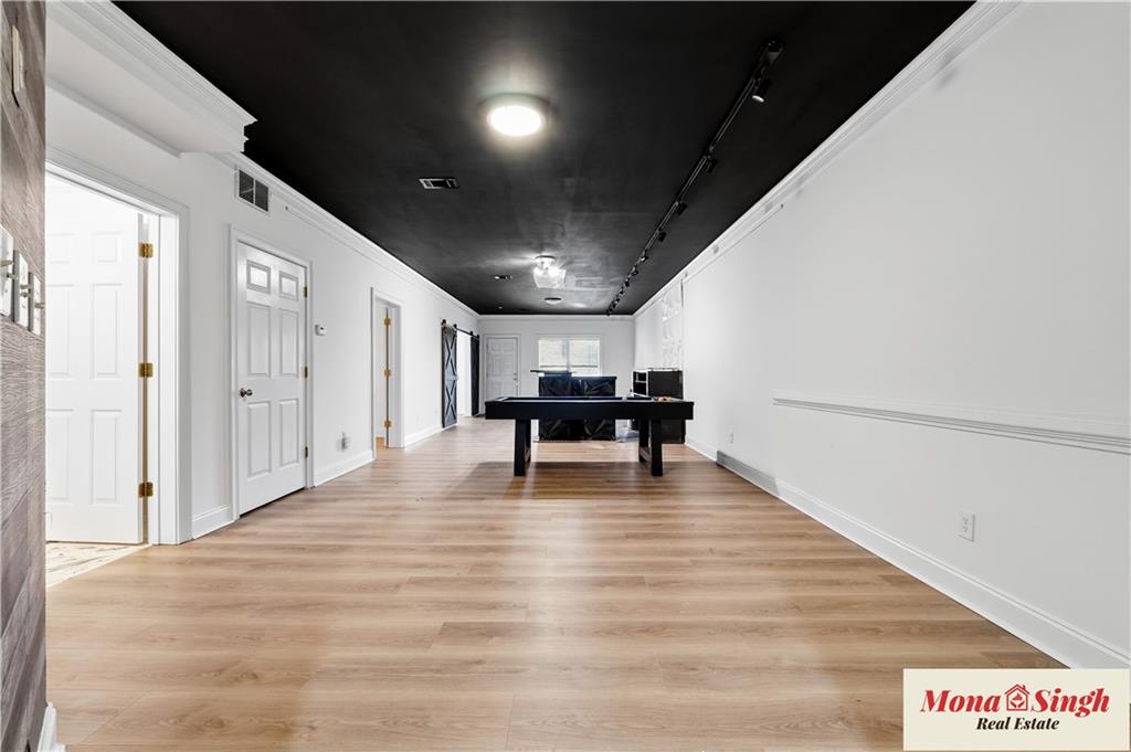 6961 Fellowship Lane Flowery Branch, GA 30542 - Photo 33 of 47 a view of an empty room with wooden floor