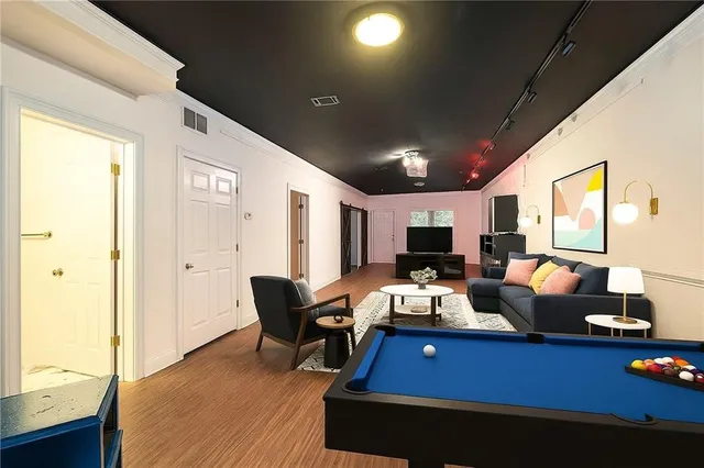 a living room with furniture fireplace and a large window