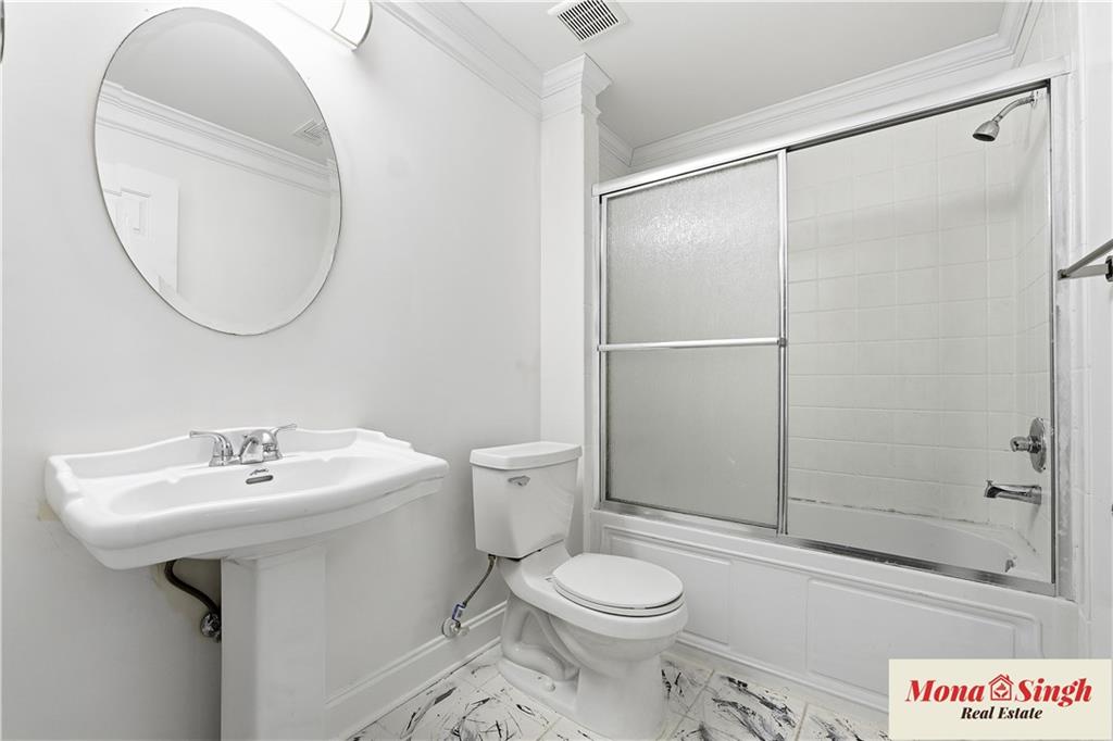 6961 Fellowship Lane Flowery Branch, GA 30542 - Photo 35 of 47 a bathroom with a sink toilet and shower