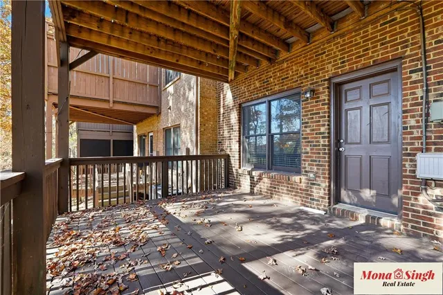 a view of a porch with wooden floor and fence