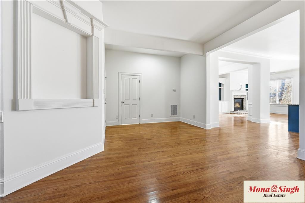 6961 Fellowship Lane Flowery Branch, GA 30542 - Photo 4 of 47 a view of an empty room with wooden floor and a window