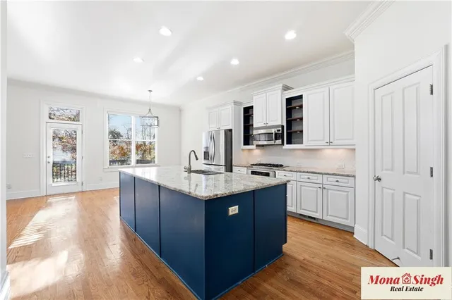 a kitchen with sink stove and cabinets