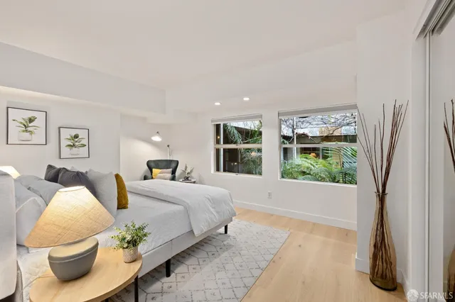 a bedroom with a large bed and a window