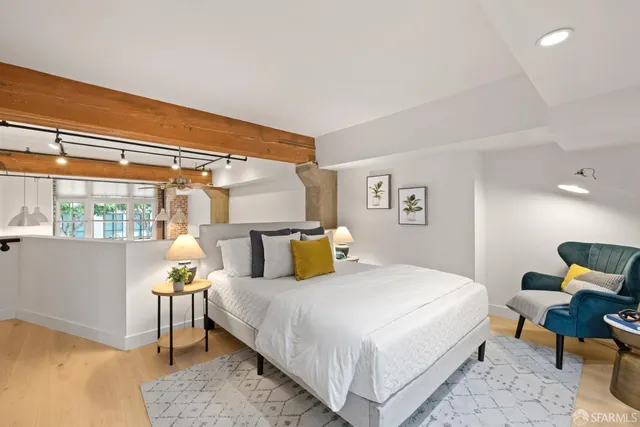 a bedroom with a bed a table and chair