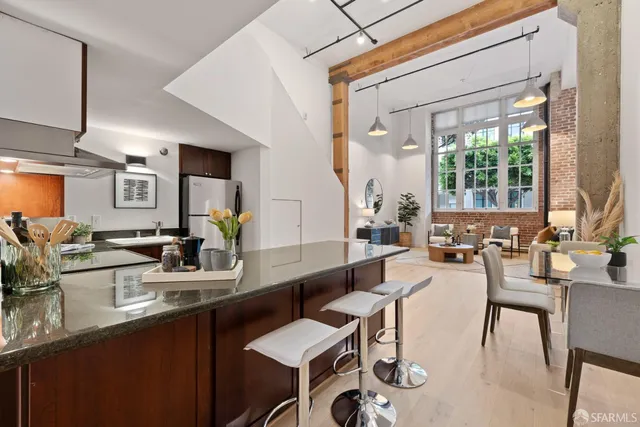 a kitchen with a sink and chairs