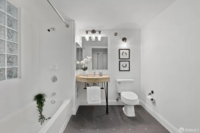 a bathroom with a toilet sink and mirror