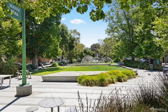 a view of backyard with swimming pool and seating space