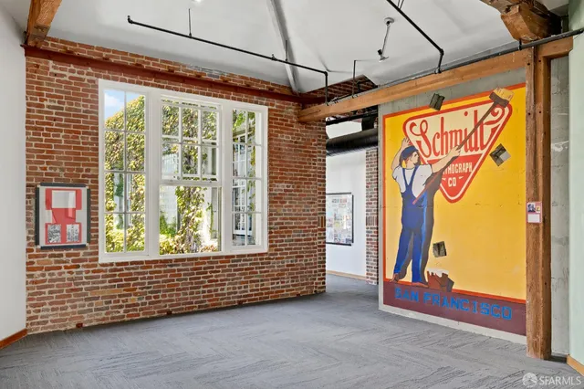 a view of a room with furniture and windows