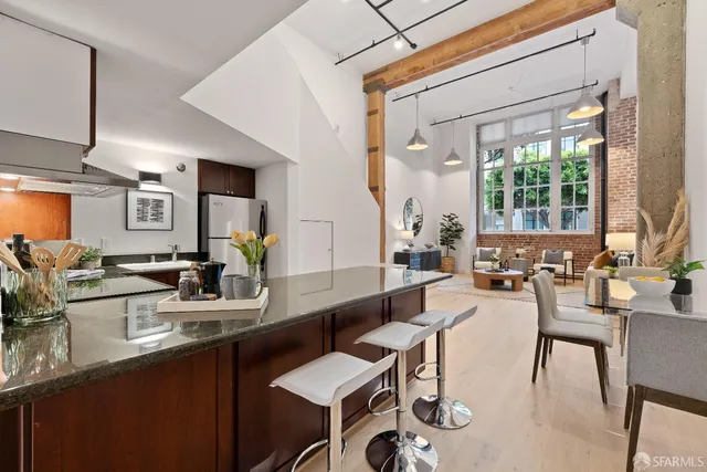 a kitchen with a sink and chairs