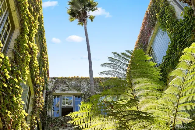 a view of a patio with couple of chairs and a fountain