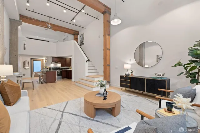 a living room with furniture a mirror and a fireplace