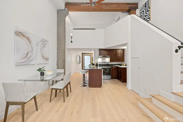 a kitchen with a sink cabinets and wooden floor