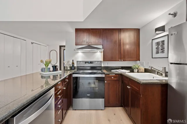 a kitchen with a sink stove and cabinets