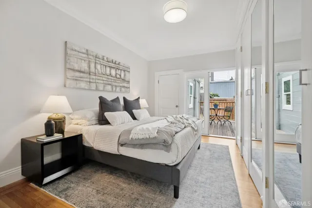 a spacious bedroom with a bed and a lamp on table