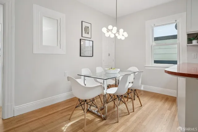 a view of a dining room with furniture wooden floor and a chandelier