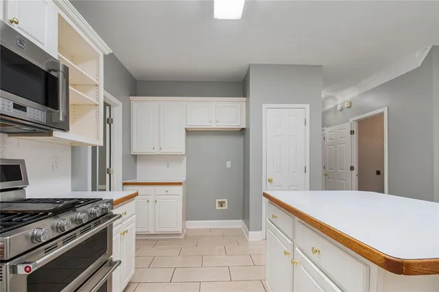 a kitchen with stainless steel appliances a stove a microwave and cabinets