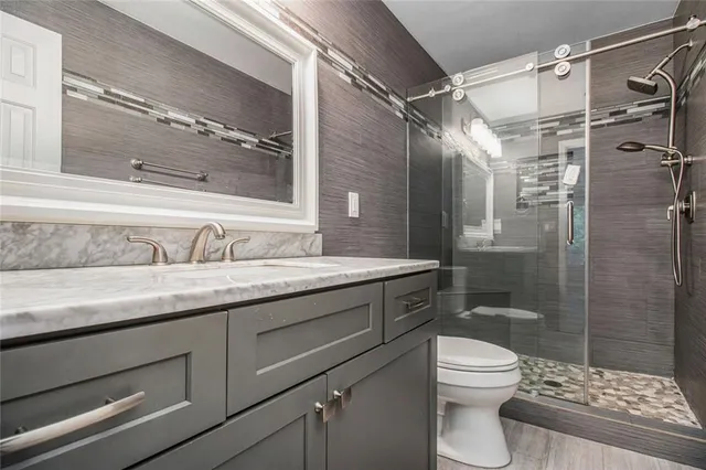 a bathroom with a sink toilet and shower