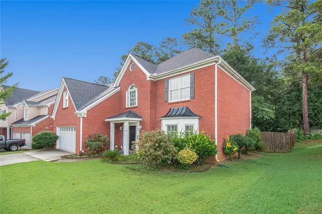 a front view of a house with a yard